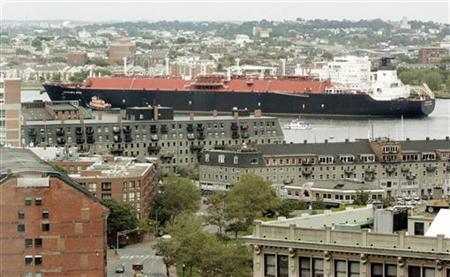 A liquefied natural gas (LNG) tanker passes downtown Boston as it navigates though Boston Harbor in Boston
